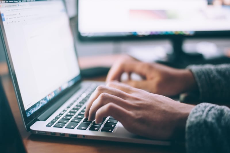 Book writing on laptop