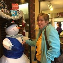 Sheila Trask laughing with fake snowman