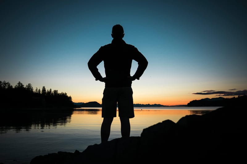 The Story Hero A Storytelling Course Man standing with hands on hips in front of lake